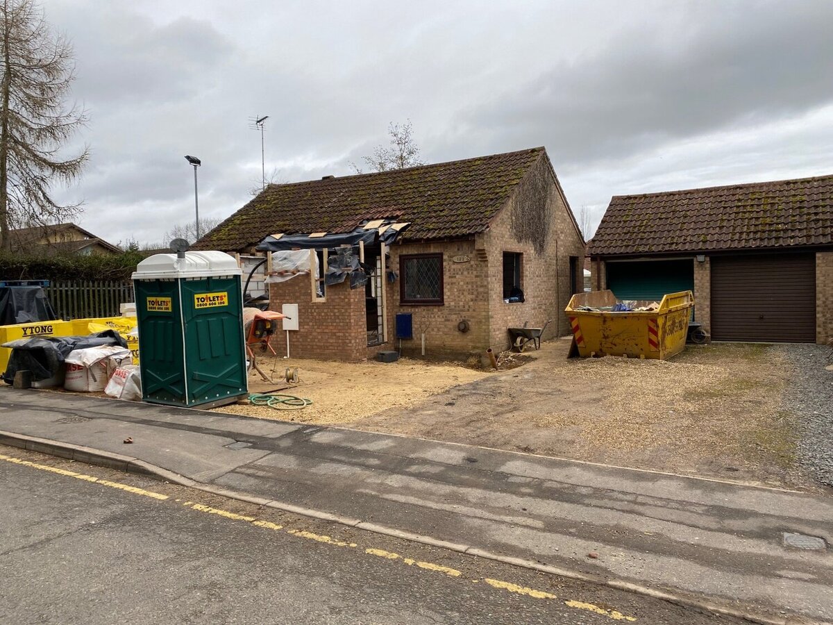 Bungalow before renovation with skip on drive