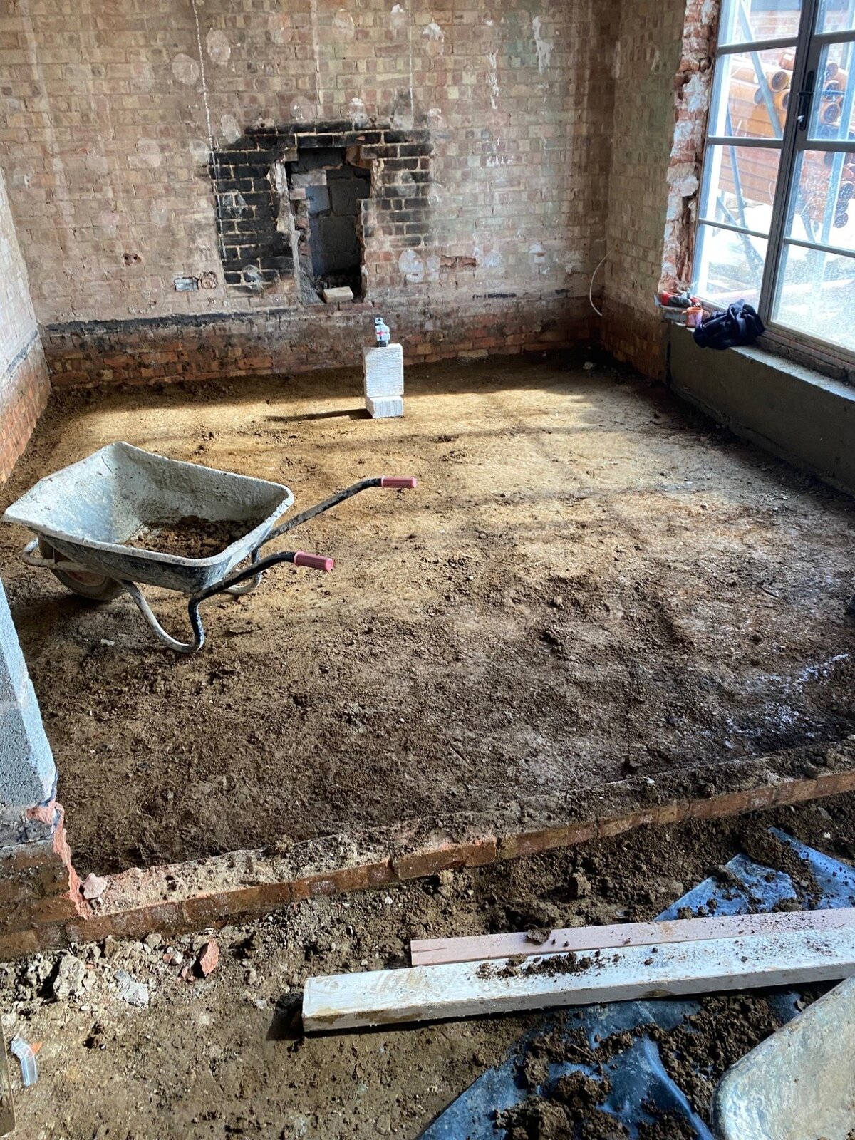 Floor dig out with wheelbarrow and bare earth