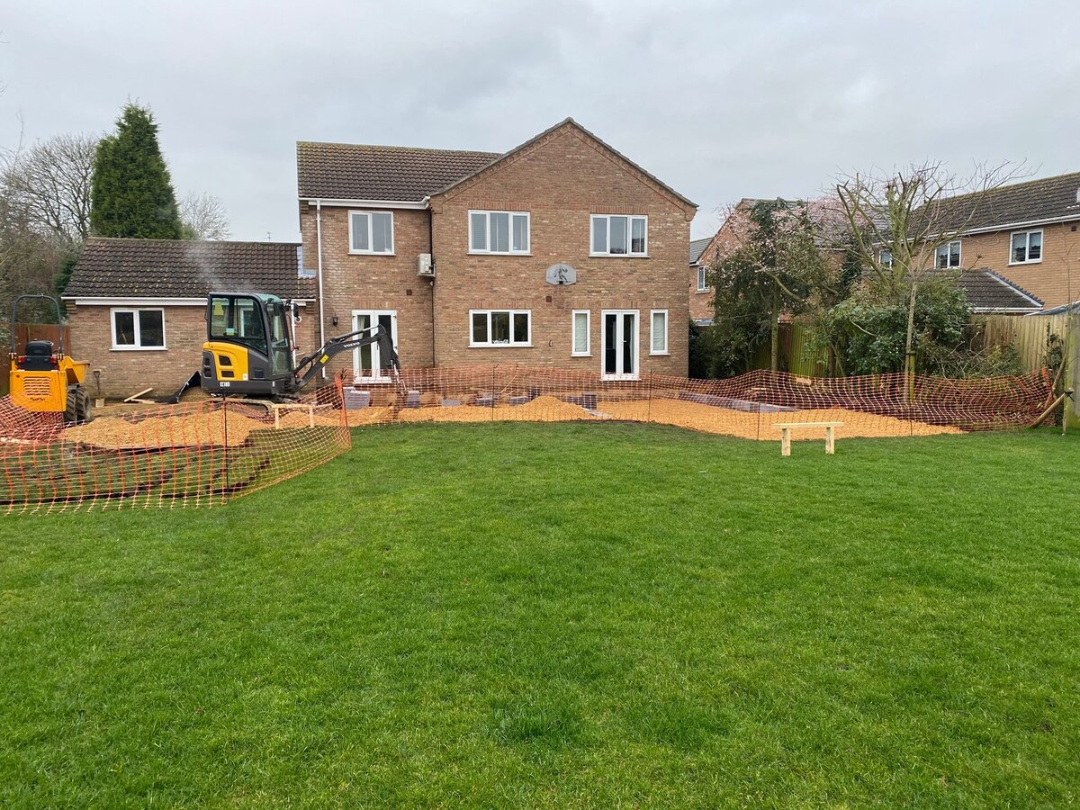 Extension foundations with orange safety fencing