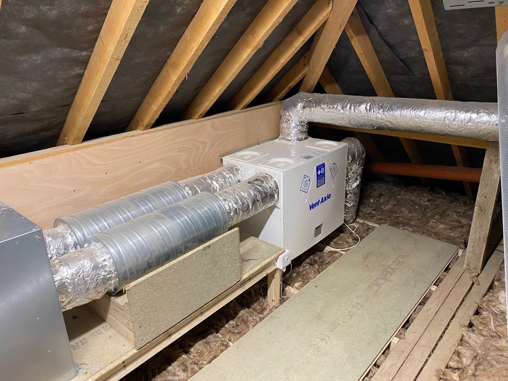 Vent-Axia MVHR heat recovery unit with ductwork in loft