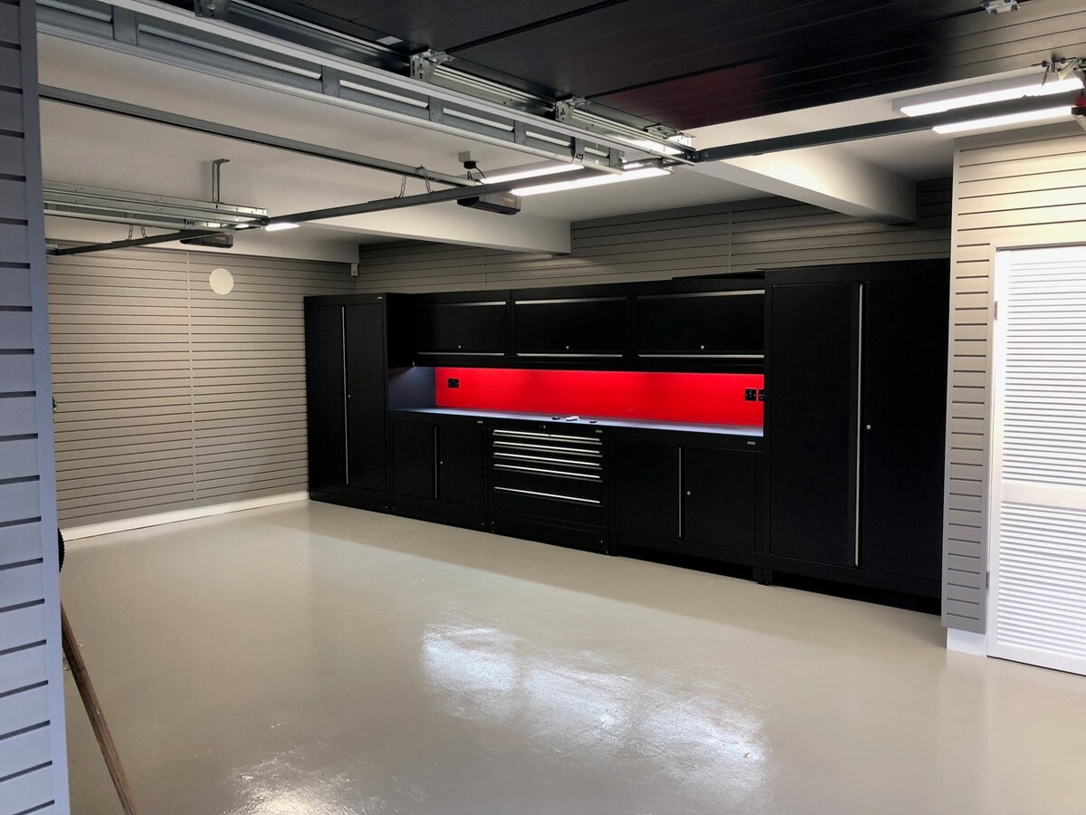 Bespoke garage interior with red backlit workbench