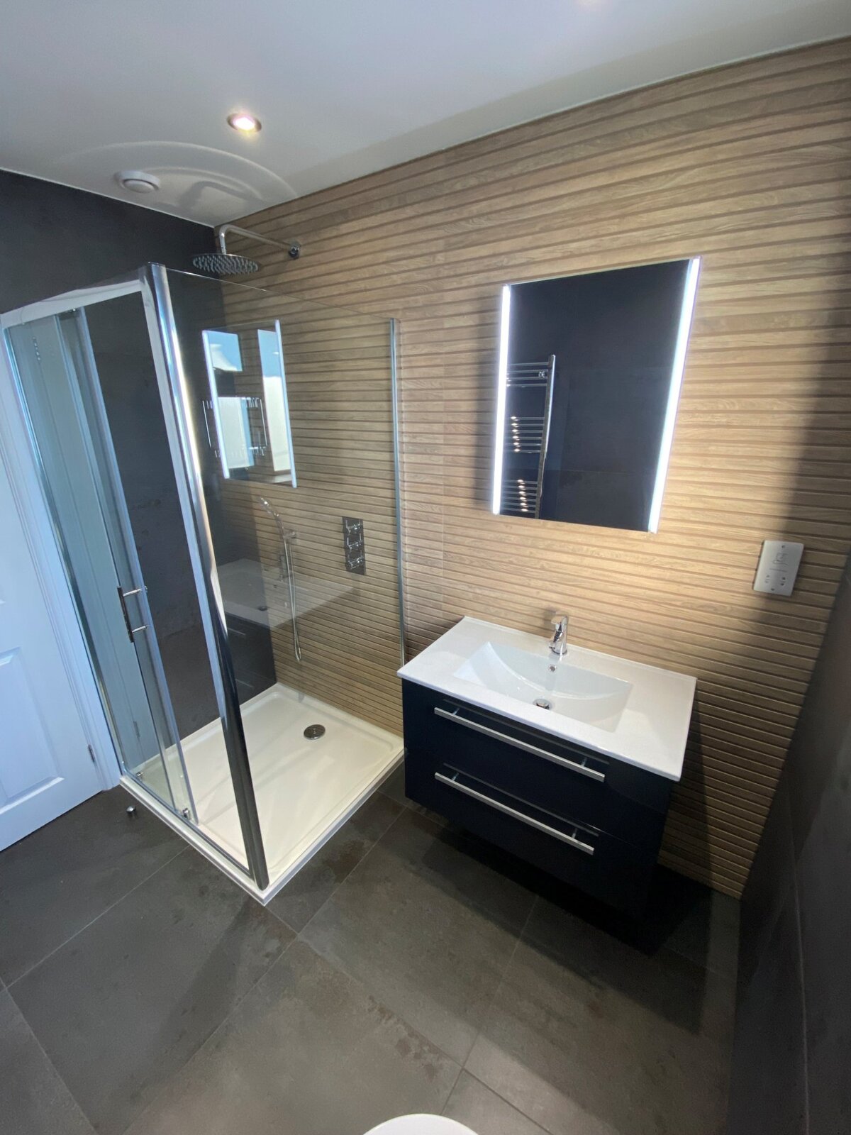 Shower room with wood effect tiles and vanity unit