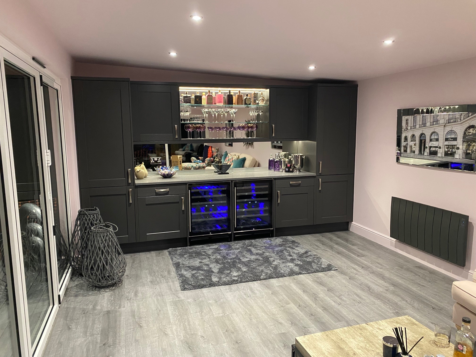 Bespoke gin bar with backlit shelving, wine fridges and quartz worktop