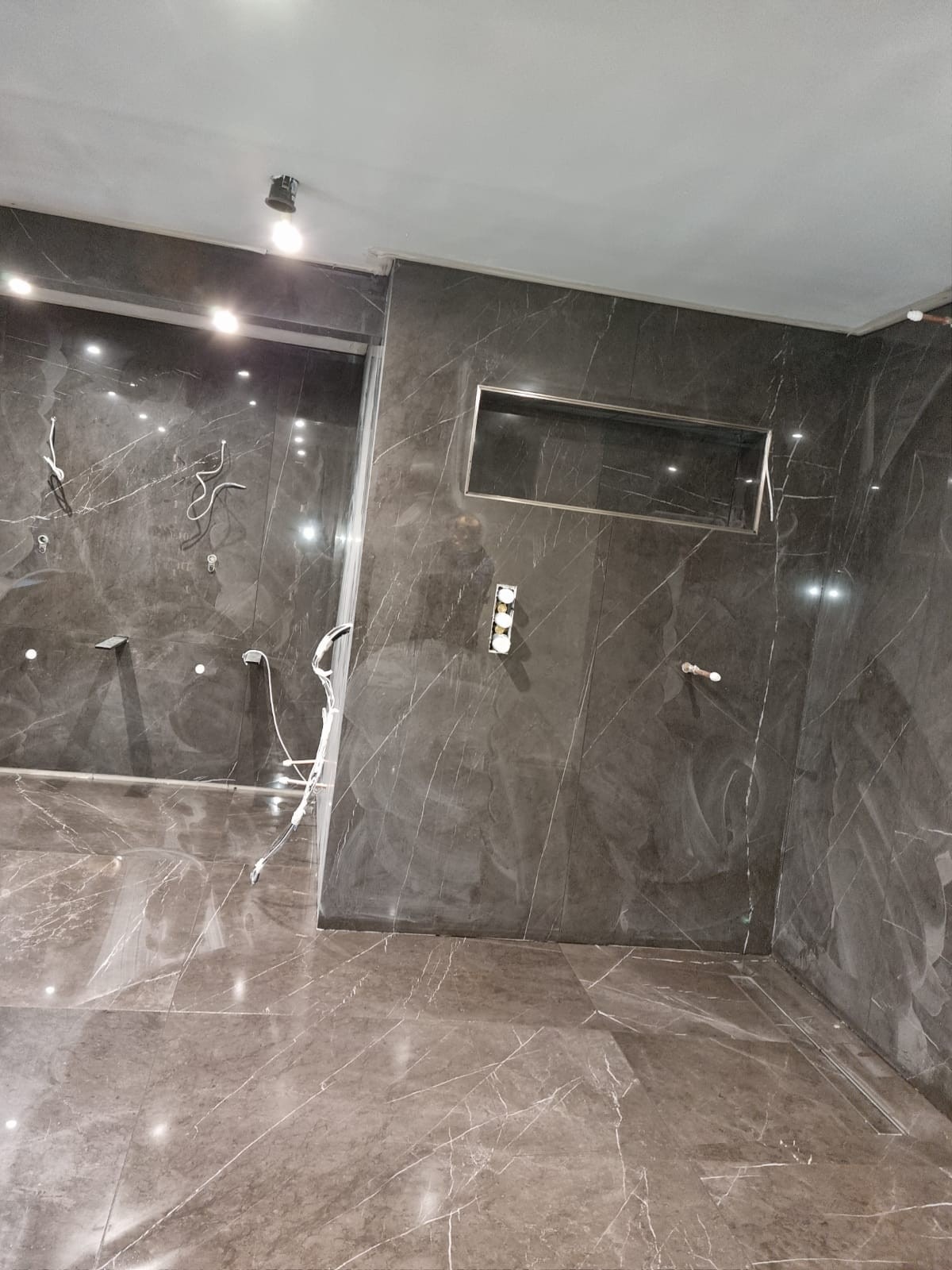 Feature bathroom wet room shower area with concealed fittings and chrome niche